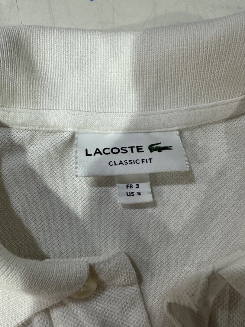 Lacoste Polo White (Category: Tshirts & Polo Shirts ) located in Butuan. Submitted by BytheriverClothing (Listing ID 1464241036, Image 2). Description: No issues Very good condition Color 9/10 Classic fit L26.5 W19 Small-Medium.