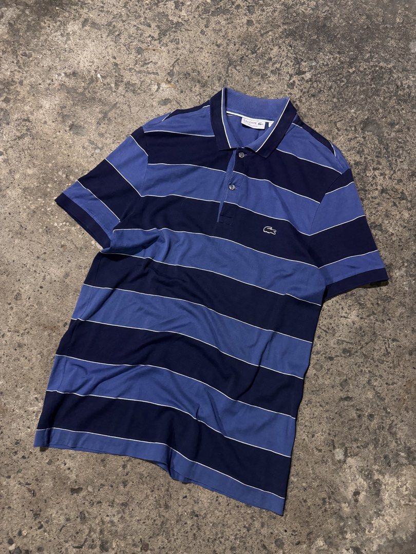 Lacoste Regular Fit Striped Polo Shirt (Category: Tshirts & Polo Shirts ) located in Pasig City. Submitted by dripthrift1600 (Listing ID 1464249289, Image 1). Description: - Classic Lacoste polo shirt - Features navy and blue horizontal stripes - Regular fit for comfortable wear - Iconic small crocodile logo on the chest - Button-up collar with stylish white trim - Ideal for casual and everyday styling - Dimes: 19x29.