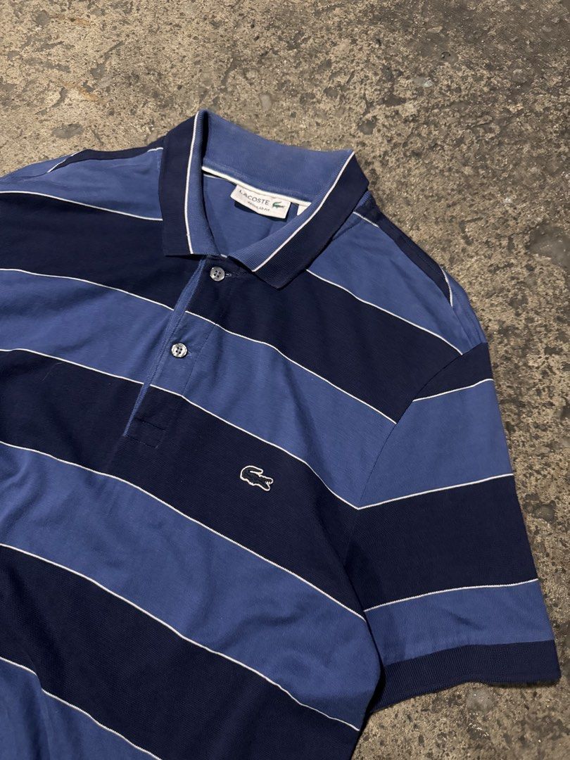 Lacoste Regular Fit Striped Polo Shirt (Category: Tshirts & Polo Shirts ) located in Pasig City. Submitted by dripthrift1600 (Listing ID 1464249289, Image 3). Description: - Classic Lacoste polo shirt - Features navy and blue horizontal stripes - Regular fit for comfortable wear - Iconic small crocodile logo on the chest - Button-up collar with stylish white trim - Ideal for casual and everyday styling - Dimes: 19x29.
