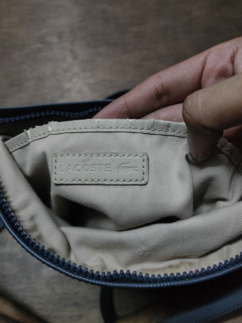 Lacoste Sleek Blue crossbody bag (Category: Luxury Bags & Wallets) located in Manila. Submitted by montillano25396 (Listing ID 1464317016, Image 3). Description: Lacoste Sleek Blue crossbody bag Size: Medium Good Condition Issue: minimal crack spot inside.