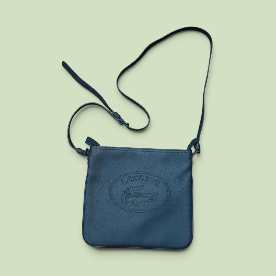 Lacoste Sleek Blue crossbody bag (Category: Luxury Bags & Wallets) located in Manila. Submitted by montillano25396 (Listing ID 1464317016, Image 1). Description: Lacoste Sleek Blue crossbody bag Size: Medium Good Condition Issue: minimal crack spot inside.