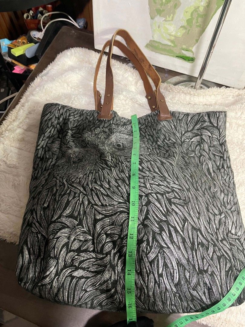 Large Fabric Tote Bag with Leather Straps (Category: Tote Bags) located in Naawan. Submitted by twilly.apparel2 (Listing ID 1464221541, Image 3). Description: - Spacious tote bag with a unique leaf print - Sturdy leather handles - Ideal for everyday use, shopping, or travel - Plenty of room for essentials - Nice fabric texture - Approximate dimensions: 16" wide x 17" tall.