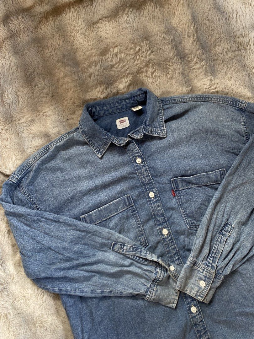Levi's Denim Shirt Blue Size S (Category: Coats, Jackets and Outerwear) located in Andop. Submitted by safewater-895a (Listing ID 1464197464, Image 2). Description: - Classic Levi's denim shirt - Blue wash - Two chest pockets with button closure - Button-up front - Long sleeves with button cuffs - 100% cotton - Tagged S/P/CH - Width: 24 - Lenght: 27.