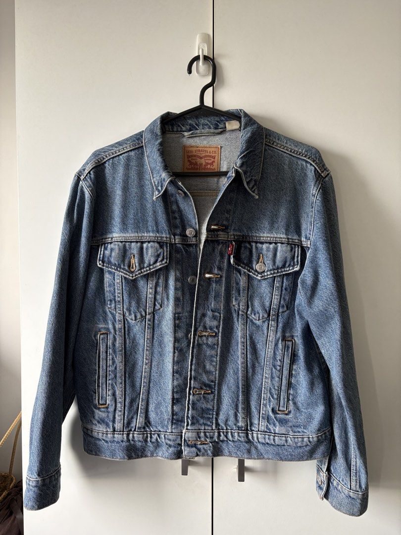 Levi's Trucker Denim Jacket Blue (Category: Coats, Jackets and Outerwear) located in Quezon City. Submitted by misserika (Listing ID 1464205323, Image 1). Description: - Classic Levi's denim jacket - Blue wash, heavy denim - Standard trucker style - Button closure - Chest pockets - Durable denim construction - Versatile for layering or standalone wear - Stored for a few months, needs dry cleaning.