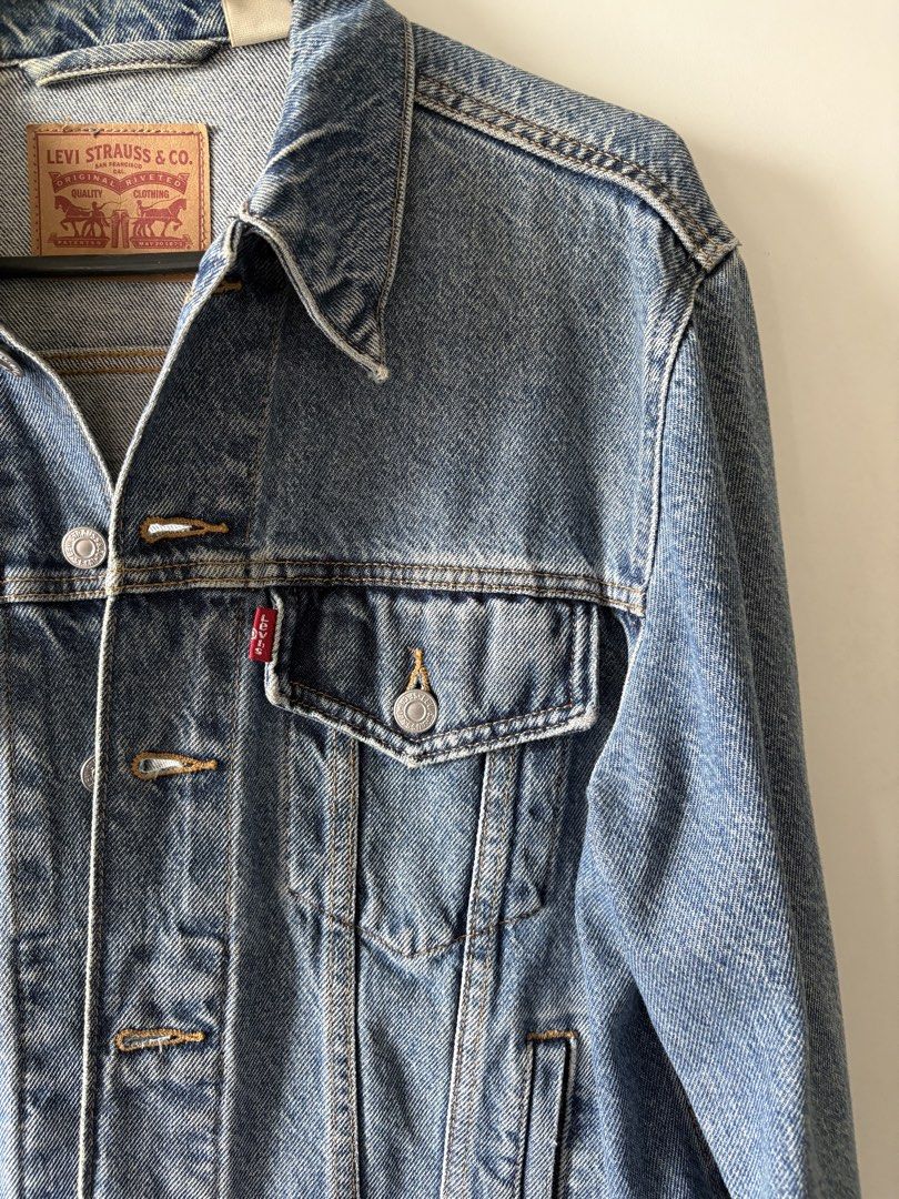 Levi's Trucker Denim Jacket Blue (Category: Coats, Jackets and Outerwear) located in Quezon City. Submitted by misserika (Listing ID 1464205323, Image 3). Description: - Classic Levi's denim jacket - Blue wash, heavy denim - Standard trucker style - Button closure - Chest pockets - Durable denim construction - Versatile for layering or standalone wear - Stored for a few months, needs dry cleaning.