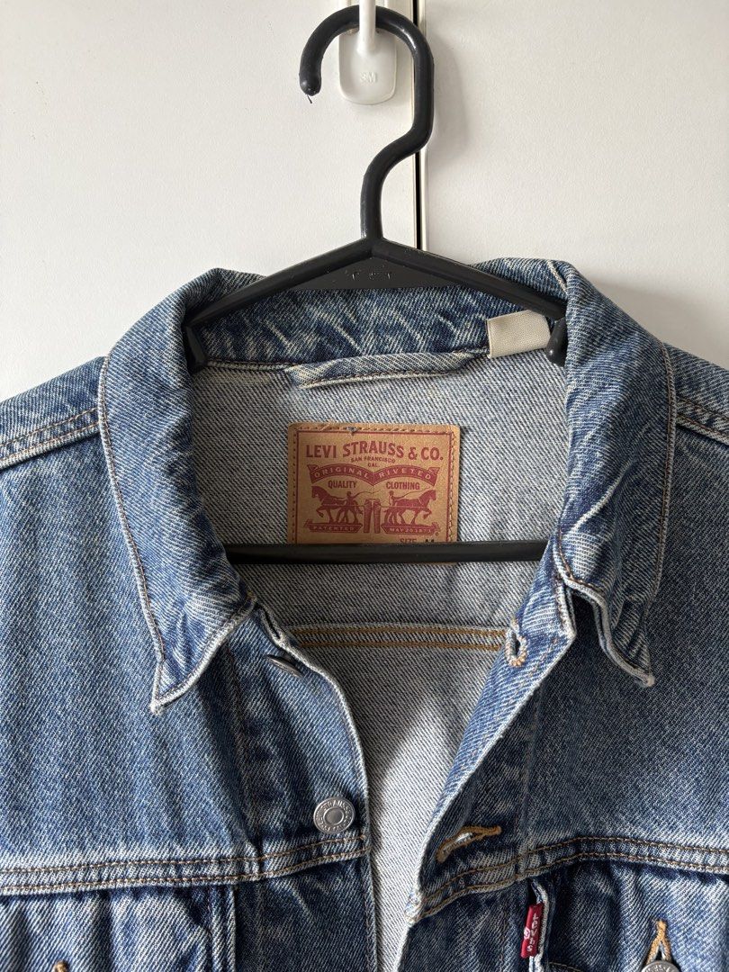 Levi's Trucker Denim Jacket Blue (Category: Coats, Jackets and Outerwear) located in Quezon City. Submitted by misserika (Listing ID 1464205323, Image 2). Description: - Classic Levi's denim jacket - Blue wash, heavy denim - Standard trucker style - Button closure - Chest pockets - Durable denim construction - Versatile for layering or standalone wear - Stored for a few months, needs dry cleaning.