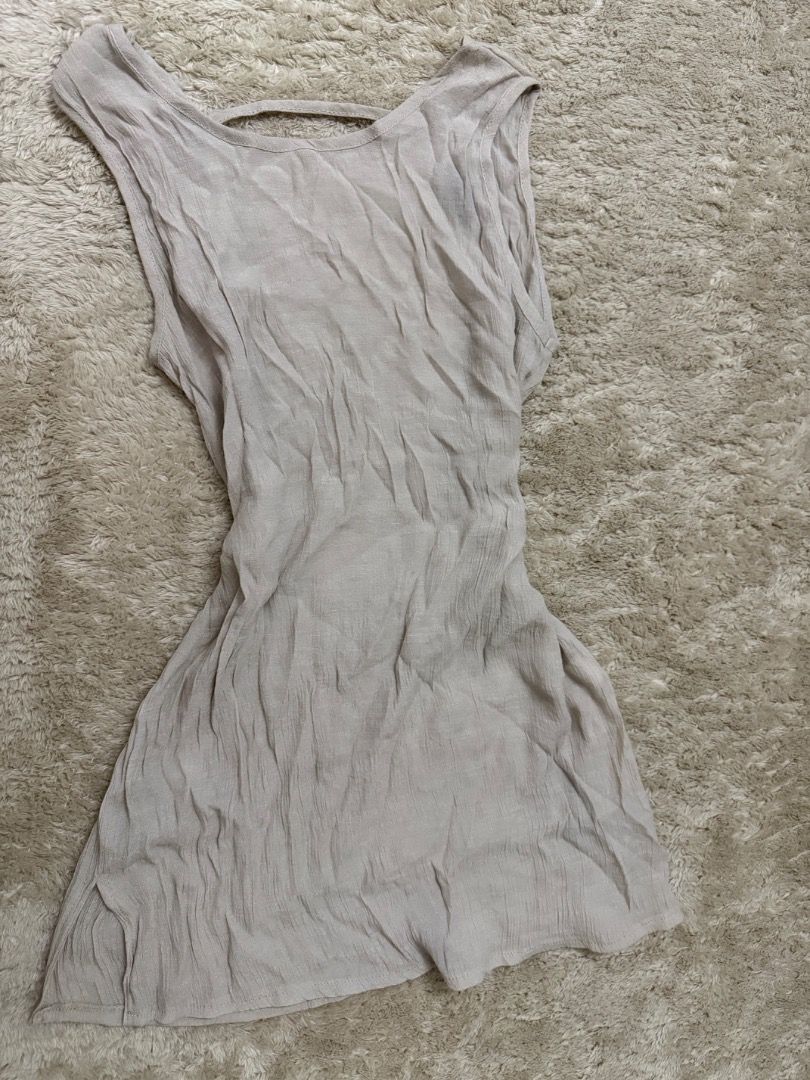 Light Beige beach cover up (Category: Sleeveless) located in Caloocan City. Submitted by croissant8765 (Listing ID 1464312909, Image 3). Description: - Light beige sleeveless tank top - Low scoop neckline - Open back with strap detail - Crinkled fabric texture - Relaxed fit - Perfect for layering or wearing solo.