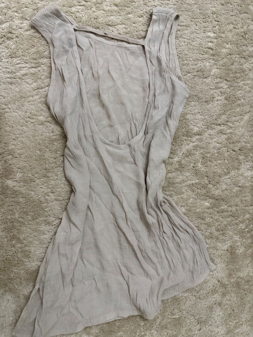 Light Beige beach cover up (Category: Sleeveless) located in Caloocan City. Submitted by croissant8765 (Listing ID 1464312909, Image 2). Description: - Light beige sleeveless tank top - Low scoop neckline - Open back with strap detail - Crinkled fabric texture - Relaxed fit - Perfect for layering or wearing solo.
