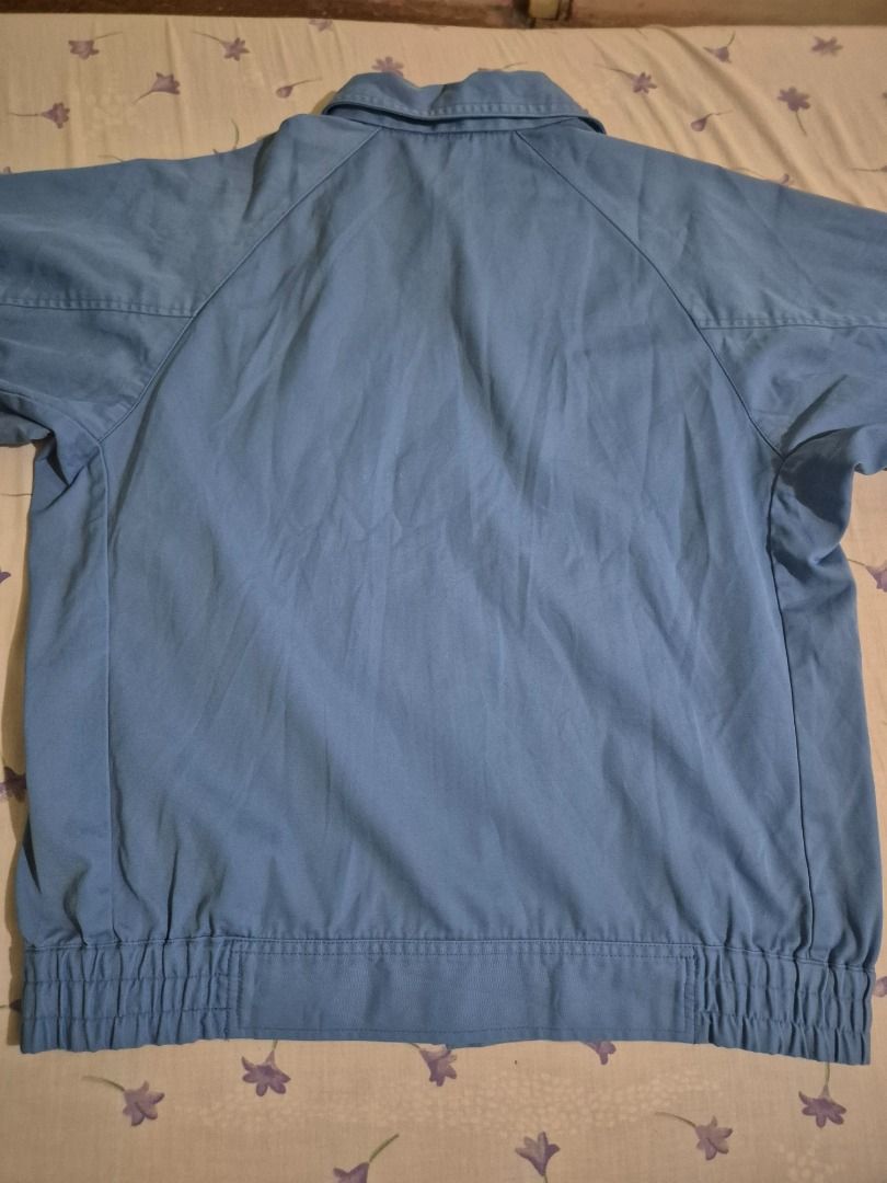 Light Blue Work Jacket (Category: Coats, Jackets and Outerwear) located in Caloocan City. Submitted by lecitoyen2026 (Listing ID 1464184875, Image 3). Description: - Light blue work jacket - Two dark blue chest pockets with button closure - Elasticated waistband and cuffs - Suitable for work or casual wear.