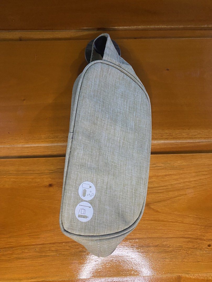 Light Grey Toiletry Bag / Travel Pouch (Category: Purses & Pouches) located in Manila. Submitted by heath2600 (Listing ID 1464300372, Image 2). Description: - Light grey toiletry bag - Convenient side handle for easy carrying - Subtle textured fabric - Printed icons on the front indicating toiletry use - Secure zipper closure - Ideal for travel or everyday organization.