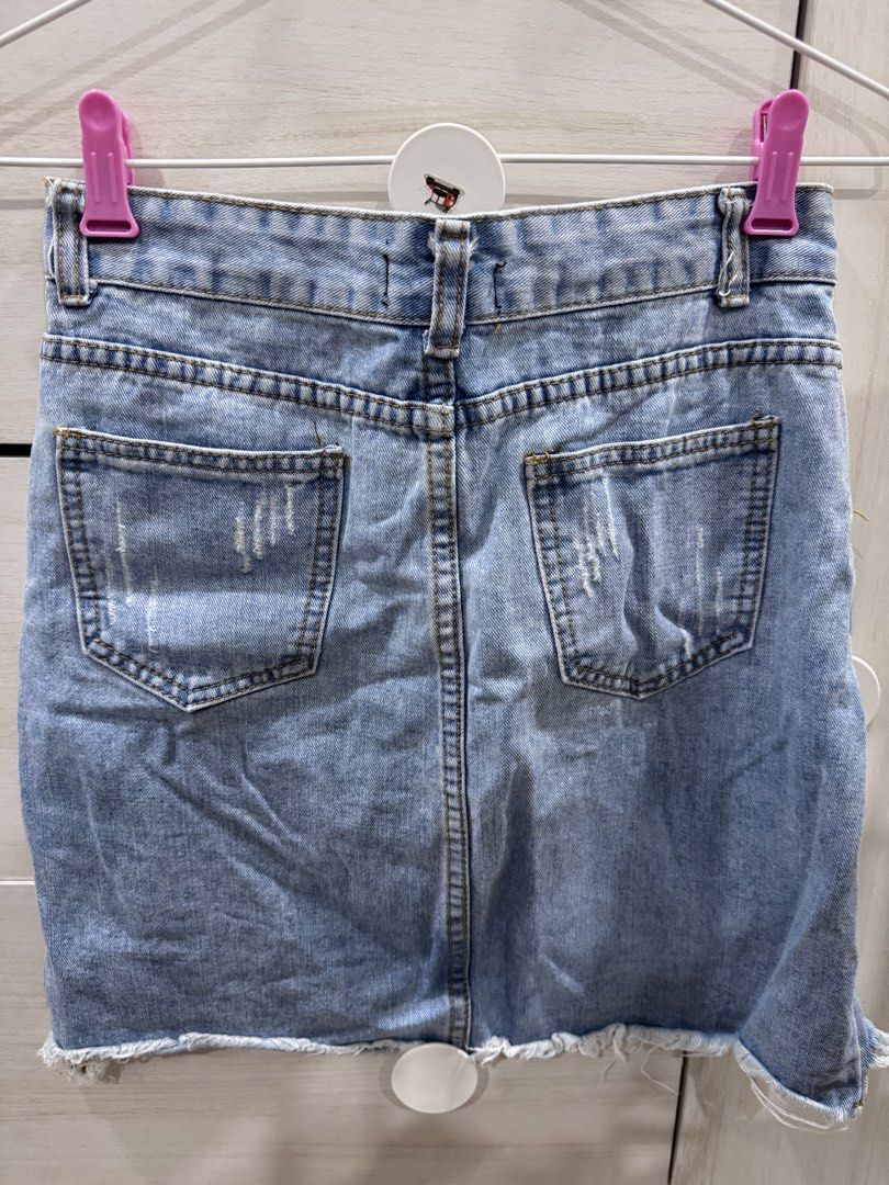 Light Wash Distressed Denim Mini Skirt (Category: Skirts) located in Iloilo. Submitted by ele.girl (Listing ID 1464270231, Image 2). Description: - Light wash denim mini skirt - Distressed details and frayed hem - Classic five-pocket styling - Button and zip closure - Versatile for casual outfits with t-shirts or crop tops.