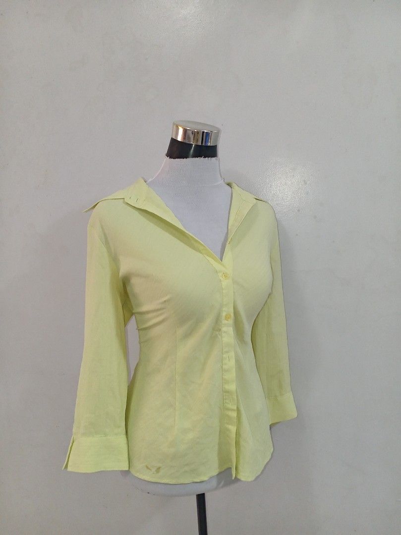 Light Yellow Button-Up Shirt with 3/4 Sleeves (Category: Blouses) located in Paranaque City. Submitted by janella11 (Listing ID 1464191667, Image 3). Description: - Light yellow button-up shirt - Three-quarter sleeves with flared cuffs - Classic collar - Versatile for casual or work outfits - Pairs well with jeans or trousers.