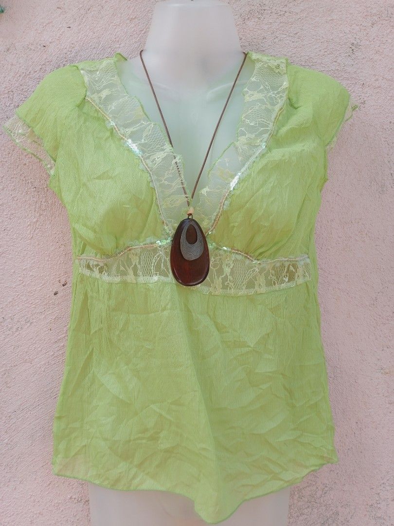 Lime Green Sheer Lace Trimmed Top (Category: Sleeveless) located in Placer. Submitted by whimsythrifts (Listing ID 1464207001, Image 1). Description: - Light lime green sheer top - Crinkled fabric texture - Lace trim with sequins on neckline and waist - Short sleeves - Comes with a brown and silver pendant necklace - Suitable for casual or dressy outfits.