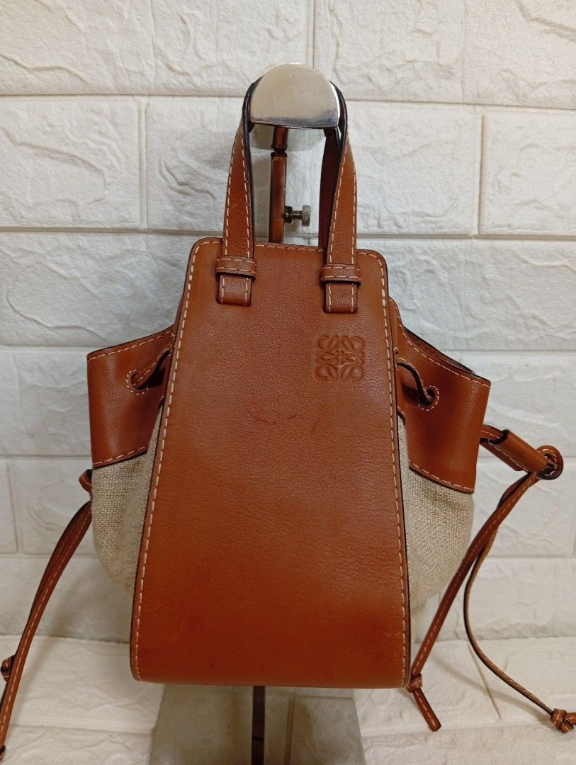 Loewe Small Mini Hammock Drawstring Bag Tan Leather Canvas (Category: Shoulder Bags) located in Las Pinas. Submitted by etoksi1234 (Listing ID 1464200298, Image 1). Description: Pre-loved Loewe Mini Hammock Drawstring Bag, showcasing tan calfskin leather contrasted with natural canvas side panels and an embossed Anagram logo..