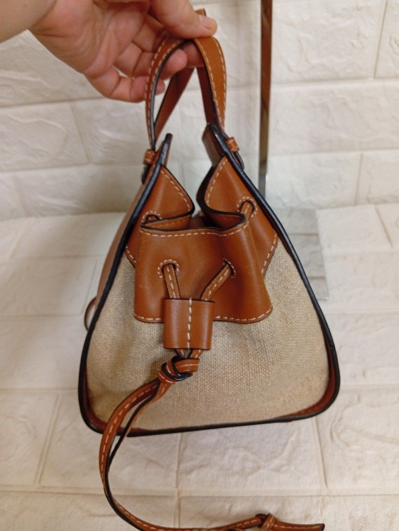 Loewe Small Mini Hammock Drawstring Bag Tan Leather Canvas (Category: Shoulder Bags) located in Las Pinas. Submitted by etoksi1234 (Listing ID 1464200298, Image 3). Description: Pre-loved Loewe Mini Hammock Drawstring Bag, showcasing tan calfskin leather contrasted with natural canvas side panels and an embossed Anagram logo..