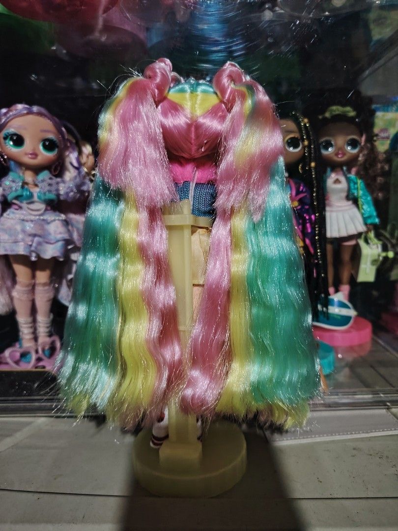 LOL Surprise OMG Doll Bubblegum DJ (Category: Kids Toys) located in Surallah. Submitted by alyssa.bisnar0712 (Listing ID 1464293543, Image 3). Description: - Super cute LOL Surprise OMG doll - Features long, wavy rainbow hair in teal, yellow, and pink - Outfit includes a blue sparkly top with pink fuzzy trim - Gold skirt with 'OMG LOL' print - Pink leg warmers - White shoes with red straps - Ideal for LOL doll collectors and playtime fun.