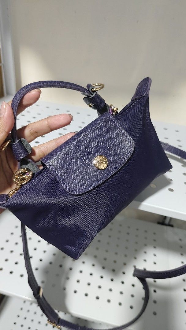 Longchamp Le Pliage Cuir Mini Top Handle Bag (Category: Luxury Bags & Wallets) located in Antipolo. Submitted by robannrave98496 (Listing ID 1464277154, Image 2). Description: - Dark purple Longchamp mini bag - Nylon body with leather trim - Features top handles - Includes a detachable crossbody strap - Accented with gold hardware - Small size, ideal for essentials - Adds a perfect pop of color to any outfit.