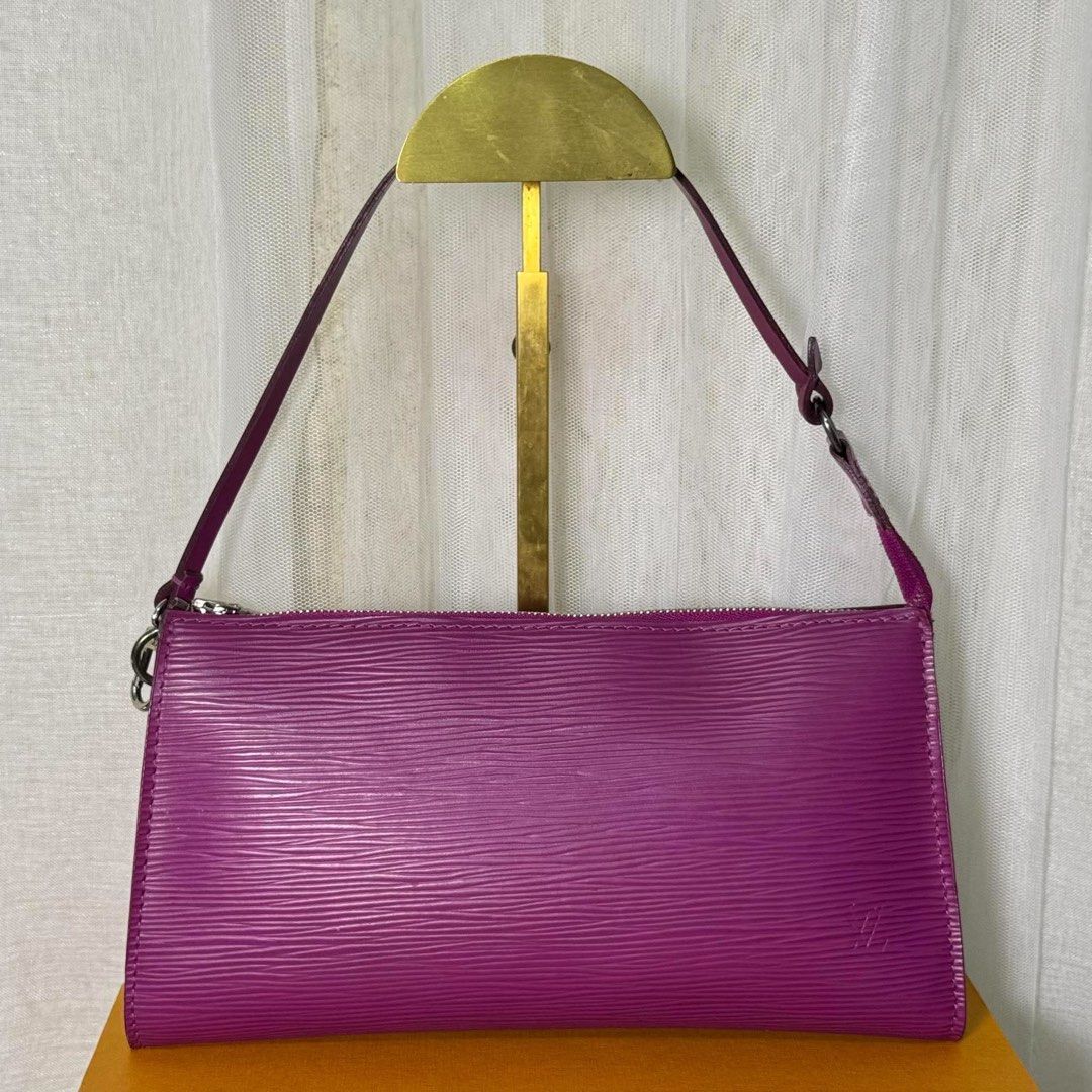 Louis Vuitton Epi Leather Pochette (Category: Luxury Bags & Wallets) located in Madrid. Submitted by jhunaceee (Listing ID 1464293882, Image 2). Description: - Authentic Louis Vuitton Pochette - Vibrant purple Epi leather - Classic rectangular shape - Secure zip closure - Adjustable strap for comfort - Perfect size for essentials - Includes original Louis Vuitton box and dust bag - Versatile for day or night use.