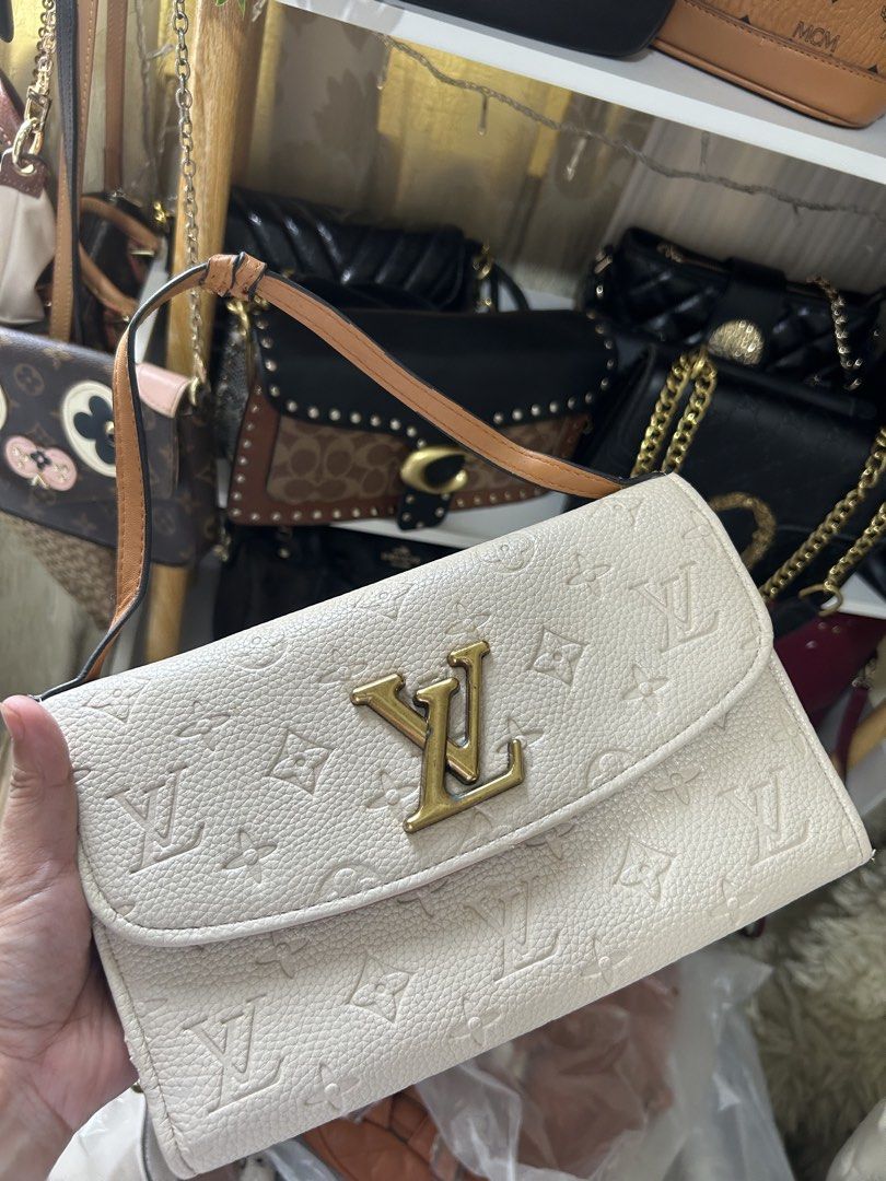 Louis Vuitton Monogrammed White Clutch Bag (Category: Luxury Bags & Wallets) located in Manila. Submitted by gleglessie (Listing ID 1464213215, Image 1). Description: - Authentic White Louis Vuitton Clutch - Gold Hardware - All-over Embossed Monogram Pattern - Includes Leather Strap - Includes Chain Strap - Interior Card Slots - Interior Zip Pocket - Made in France - Ideal for Evening Wear or as a Statement Piece.