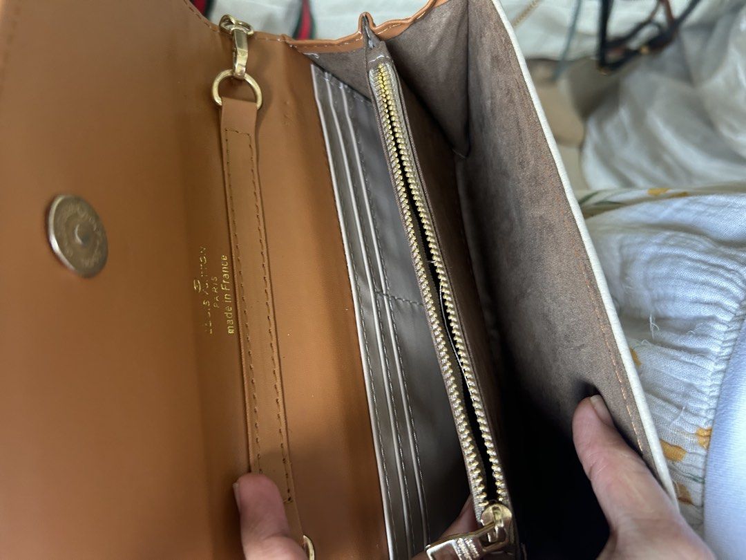 Louis Vuitton Monogrammed White Clutch Bag (Category: Luxury Bags & Wallets) located in Manila. Submitted by gleglessie (Listing ID 1464213215, Image 3). Description: - Authentic White Louis Vuitton Clutch - Gold Hardware - All-over Embossed Monogram Pattern - Includes Leather Strap - Includes Chain Strap - Interior Card Slots - Interior Zip Pocket - Made in France - Ideal for Evening Wear or as a Statement Piece.