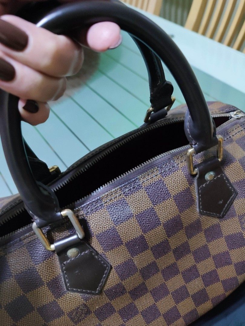 Louis Vuitton Speedy Damier Ebene Canvas Handbag (Category: Luxury Bags & Wallets) located in Pasig City. Submitted by megskee (Listing ID 1464205651, Image 2). Description: - Classic Louis Vuitton Speedy bag - Damier Ebene canvas with iconic checkered pattern - Genuine leather handles and trim -✔️ zipper need for repair - Red fabric interior lining - Perfect for everyday use Triple A Handbag.
