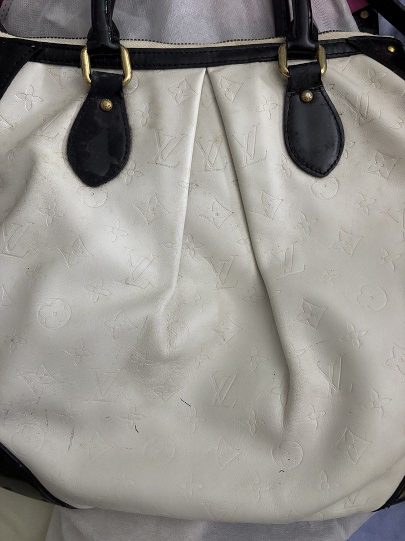 Louis Vuitton White Monogram Leather Handbag (Category: Shoulder Bags) located in Mandaluyong City. Submitted by peachy.cloud (Listing ID 1464211059, Image 1). Description: - not coded White Louis Vuitton bag - Black patent leather trim and handles - Embossed monogram pattern all over - Signs of wear and marks on white leather - Comes with a detachable strap - Ideal for everyday use.