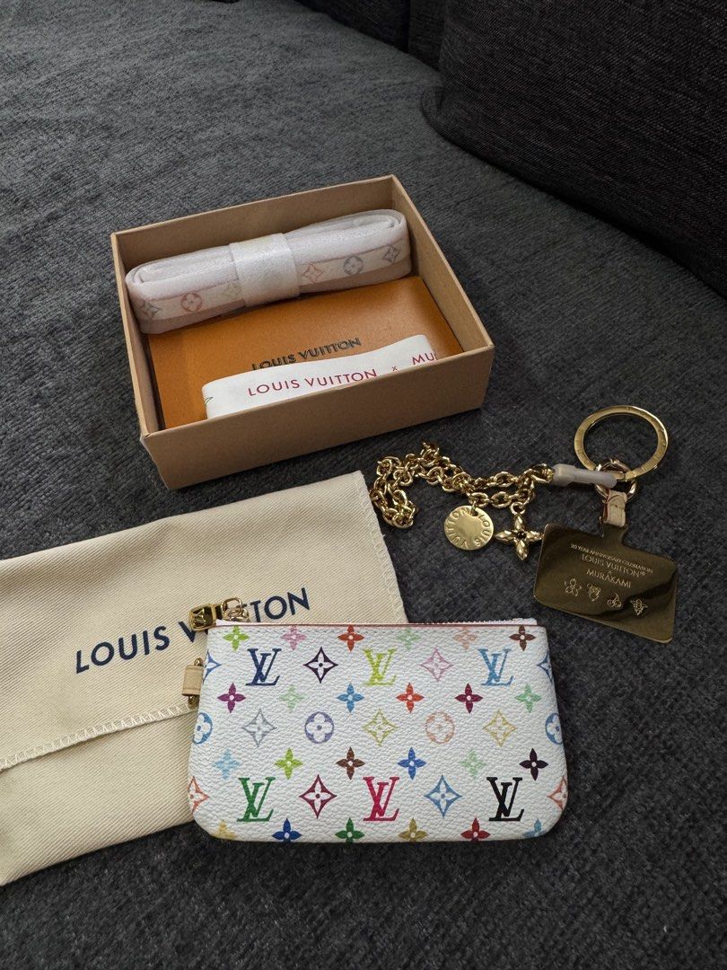 Louis Vuitton x Murakami Multicolor Monogram Pouch (Category: Luxury Bags & Wallets) located in Manila. Submitted by love_preloveddd (Listing ID 1464202260, Image 1). Description: Selling a Louis Vuitton pouch and keychain set. Features the iconic multicolor monogram pattern on the pouch. Comes with a dust bag and original box. The keychain has a charm with "20 YEAR ANNIVERSARY CREATION LOUIS VUITTON MURAKAMI" engraved. Great for organizing small