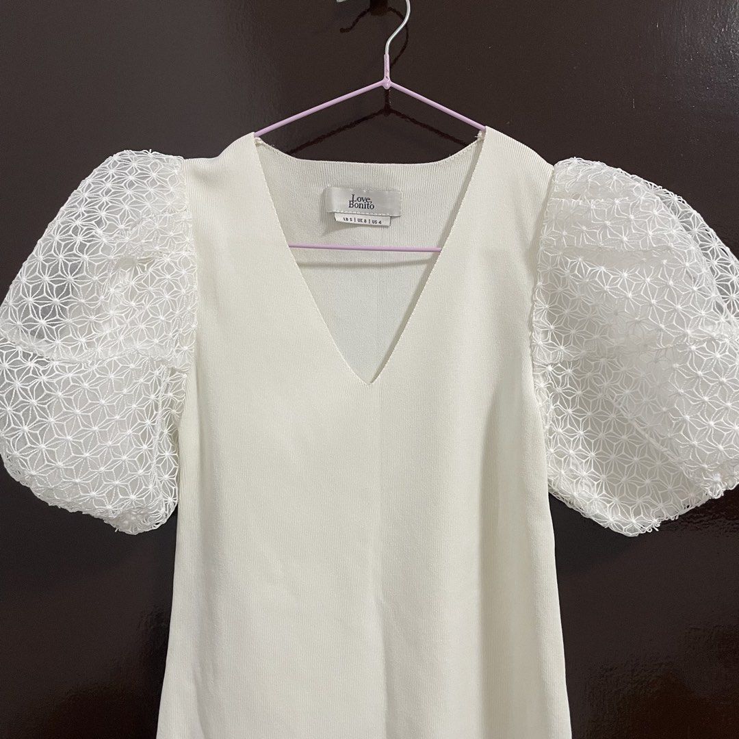 Love Bonito White Puff Sleeve Top (Category: Blouses) located in Pasay City. Submitted by lovedbyzea (Listing ID 1464300837, Image 2). Description: - with one minor stain at the back (please see photos) - Knitted Top - White top from Love Bonito - Size S - Features puff sleeves with a textured overlay - V-neckline - Perfect for dressing up or down.
