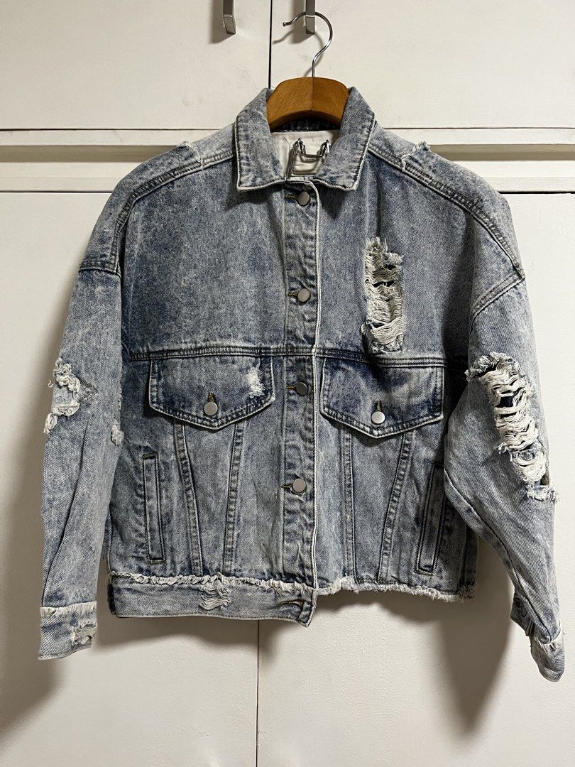 Luckyyyy Distressed Denim Jacket Size S (Category: Coats, Jackets and Outerwear) located in Manila. Submitted by lorenasant37621 (Listing ID 1464217627, Image 1). Description: - Acid wash denim jacket by Luckyyyy - Features distressed and ripped detailing throughout - Button-up front closure - Two chest pockets - Raw hemline and cuffs - Estimated size: Small (S) - Ideal for a casual and edgy aesthetic.