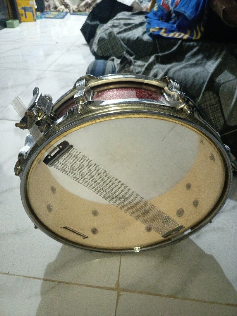 Ludwig Snare Drum (Category: Musical Instruments) located in Manila. Submitted by kibous29 (Listing ID 1464209357, Image 2). Description: - Classic Ludwig snare drum - Eye-catching red sparkle finish - Batter head shows some marks, but snare wires are intact - Perfect for practice or performance.