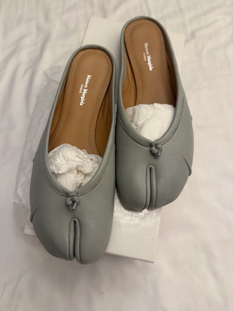 Maison Margiela Blue Leather Tabis (Category: Flats & Sandals) located in San Juan City. Submitted by andyjtan (Listing ID 1464338959, Image 1). Description: - Maison Margiela grey leather mules - Iconic split-toe design - Easy slip-on style - Comes with original box and stuffing - Adds a unique touch to any outfit.