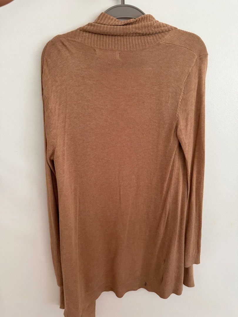 Mango Brown Knit Cardigan (Category: Coats, Jackets and Outerwear) located in Paranaque City. Submitted by ferrewr (Listing ID 1464210552, Image 2). Description: - Mango brown knit cardigan - Long sleeves - Open front style - Soft and lightweight knit - Ideal for layering over tops or dresses - Versatile for casual outings or relaxed office looks.