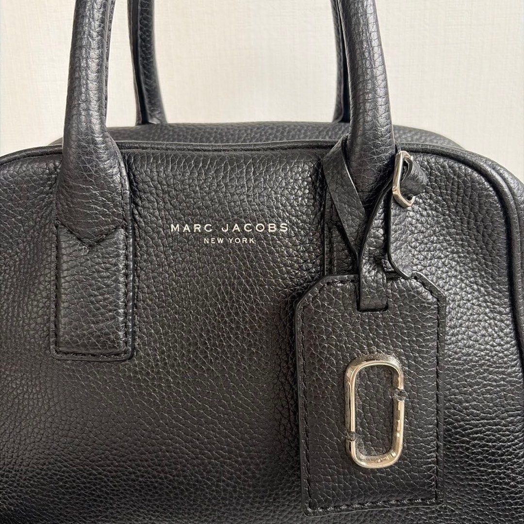 MARC JACOBS 2-Way Shoulder Bag, Black (Category: Luxury Bags & Wallets) located in Mandaluyong City. Submitted by xialeigh (Listing ID 1464345063, Image 2). Description: - Brand: Marc Jacobs - Material: Black pebbled leather - Features: Detachable striped strap, silver hardware, MJ logo tag - Interior: Plenty of space - Style: Great everyday bag.