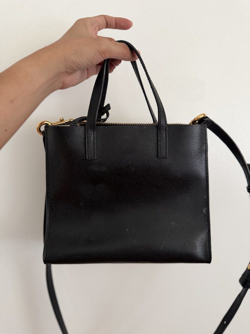 Marc Jacobs Black Leather Lock Tote Bag (Category: Tote Bags) located in Paranaque City. Submitted by ferrewr (Listing ID 1464196586, Image 2). Description: - Authentic Marc Jacobs black leather tote bag - Secure zip closure with padlock and key - Versatile wear: top handle or crossbody strap - Material: Cow split leather with polyurethane coating - Elegant gold hardware details - Authentic / Original 100% .