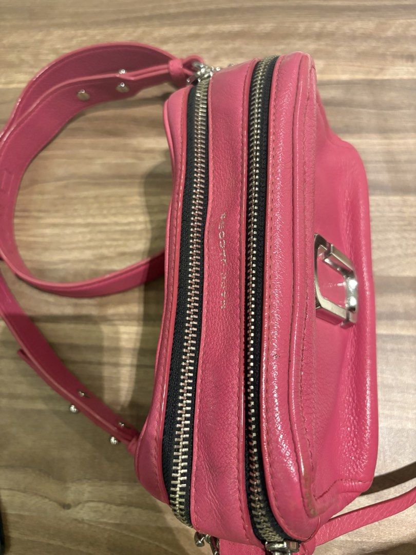 Marc Jacobs Pink Leather Snapshot Camera Bag with Strap (Category: Luxury Bags & Wallets) located in Manila. Submitted by prelovedhereee (Listing ID 1464290373, Image 3). Description: - Pink leather Marc Jacobs Snapshot camera bag - Detachable black crossbody strap with 'Marc Jacobs New York' lettering - Two zippered compartments for organization - Silver hardware details - Ideal for everyday use With extra guitar strap bought at 5K.