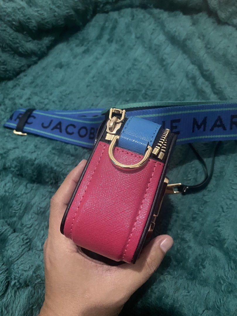 Marc Jacobs Snapshot Camera Bag with Strap (Category: Cross-body Bags) located in Antipolo. Submitted by switchneighborhood (Listing ID 1464174494, Image 2). Description: - Authentic Marc Jacobs camera bag - Vibrant purple leather with pink and blue accents - Includes the signature "The Marc Jacobs" strap - Elegant gold hardware details - Secure zipper closure - Versatile for everyday use or evening outings.