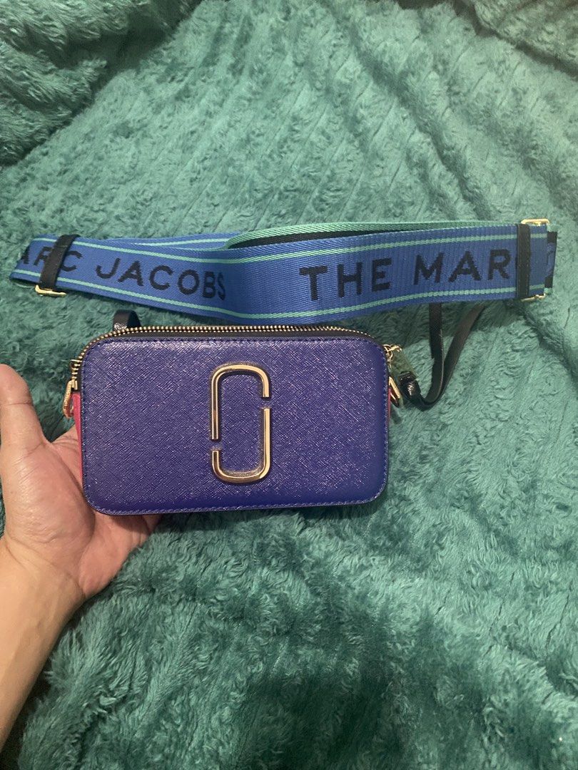 Marc Jacobs Snapshot Camera Bag with Strap (Category: Cross-body Bags) located in Antipolo. Submitted by switchneighborhood (Listing ID 1464174494, Image 1). Description: - Authentic Marc Jacobs camera bag - Vibrant purple leather with pink and blue accents - Includes the signature "The Marc Jacobs" strap - Elegant gold hardware details - Secure zipper closure - Versatile for everyday use or evening outings.