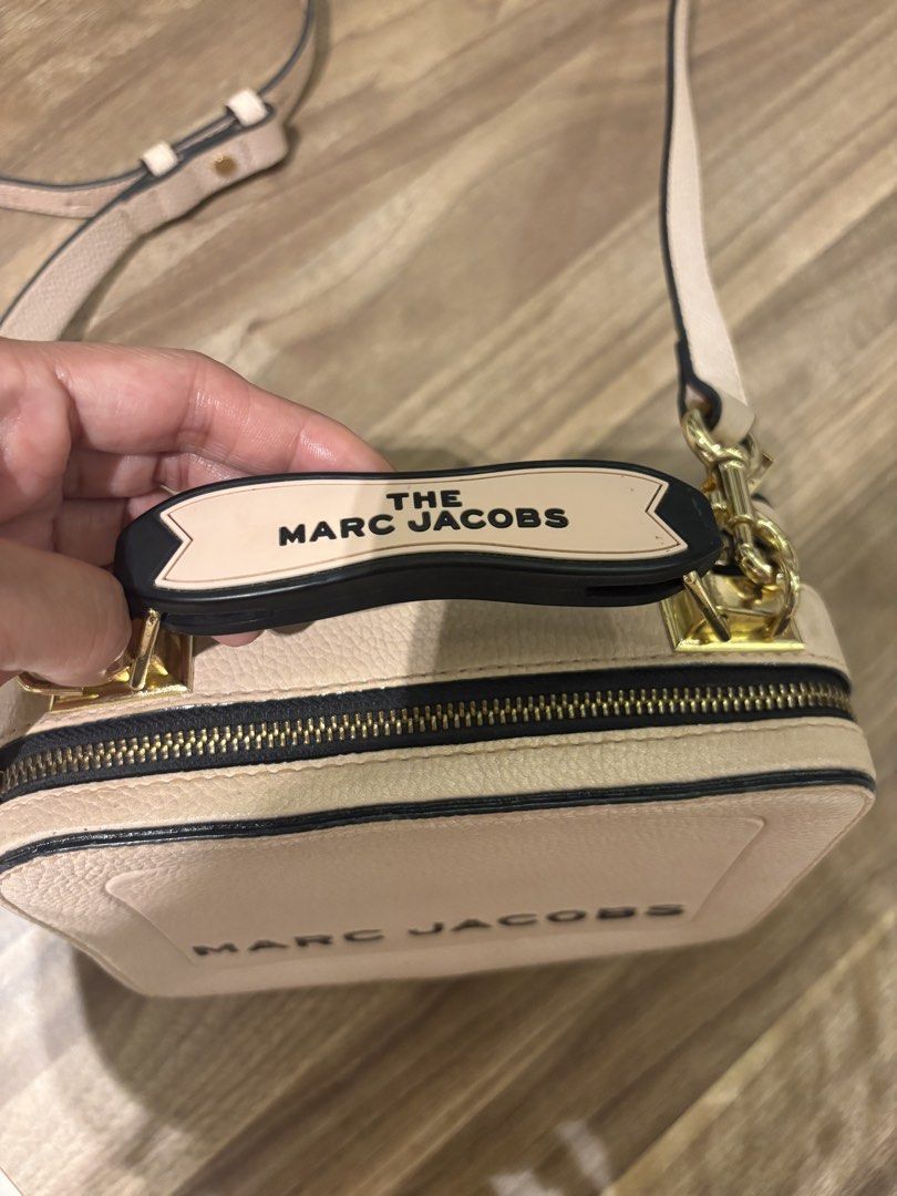 Marc Jacobs The Snapshot Camera Bag Pale Pink Leather (Category: Luxury Bags & Wallets) located in Manila. Submitted by prelovedhereee (Listing ID 1464293285, Image 1). Description: - Authentic Marc Jacobs The box bag - Color: Pale pink - Material: Pebbled leather with black trim - Hardware: Gold - Features: Signature double zip compartments, top handle - Includes: Detachable crossbody strap - Condition: Good.