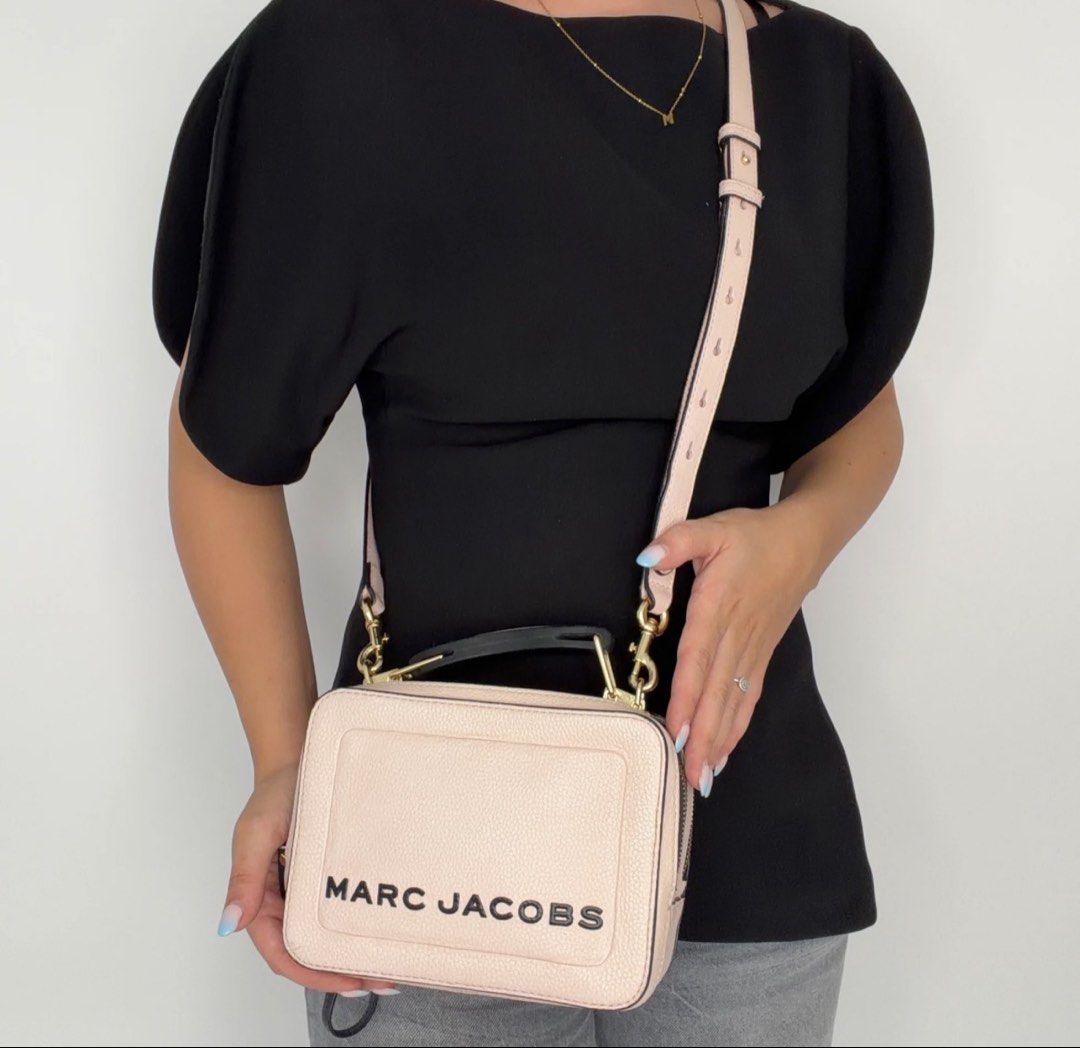 Marc Jacobs The Snapshot Camera Bag Pale Pink Leather (Category: Luxury Bags & Wallets) located in Manila. Submitted by prelovedhereee (Listing ID 1464293285, Image 2). Description: - Authentic Marc Jacobs The box bag - Color: Pale pink - Material: Pebbled leather with black trim - Hardware: Gold - Features: Signature double zip compartments, top handle - Includes: Detachable crossbody strap - Condition: Good.