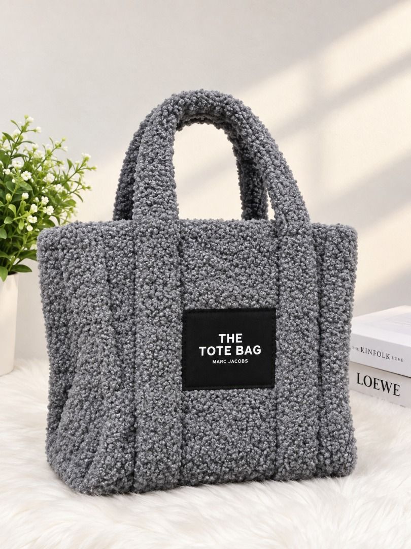 Marc Jacobs The Tote Bag - Grey Sherpa (Category: Tote Bags) located in Caloocan City. Submitted by ian04245 (Listing ID 1464261248, Image 1). Description: - Grey sherpa tote bag by Marc Jacobs - Features 'The Tote Bag' logo on the front - Includes top handles and a detachable shoulder strap - Cozy, textured material - Spacious interior for everyday essentials.