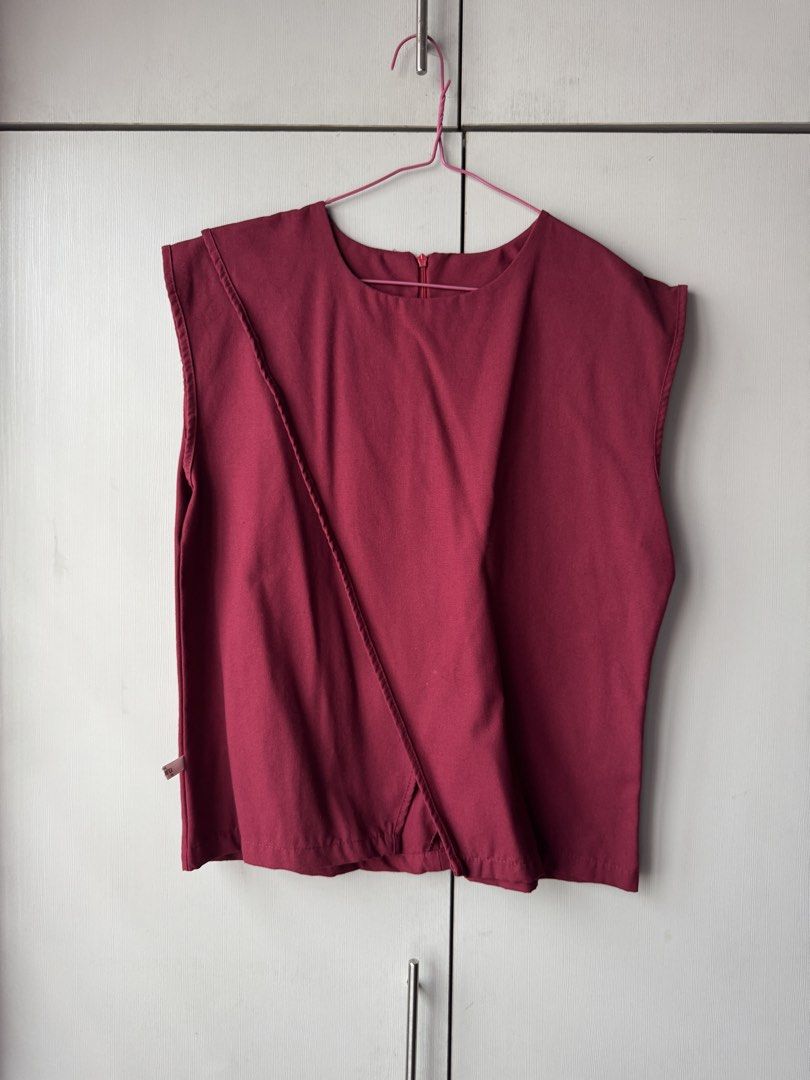 Maroon Sleeveless Top with Asymmetrical Detail (Category: Sleeveless) located in Quezon City. Submitted by jrc_98 (Listing ID 1464199522, Image 1). Description: - Maroon sleeveless top - Unique asymmetrical paneling on the front - Zipper closure at the back - Simple and chic design - Versatile for casual wear or dressing up.