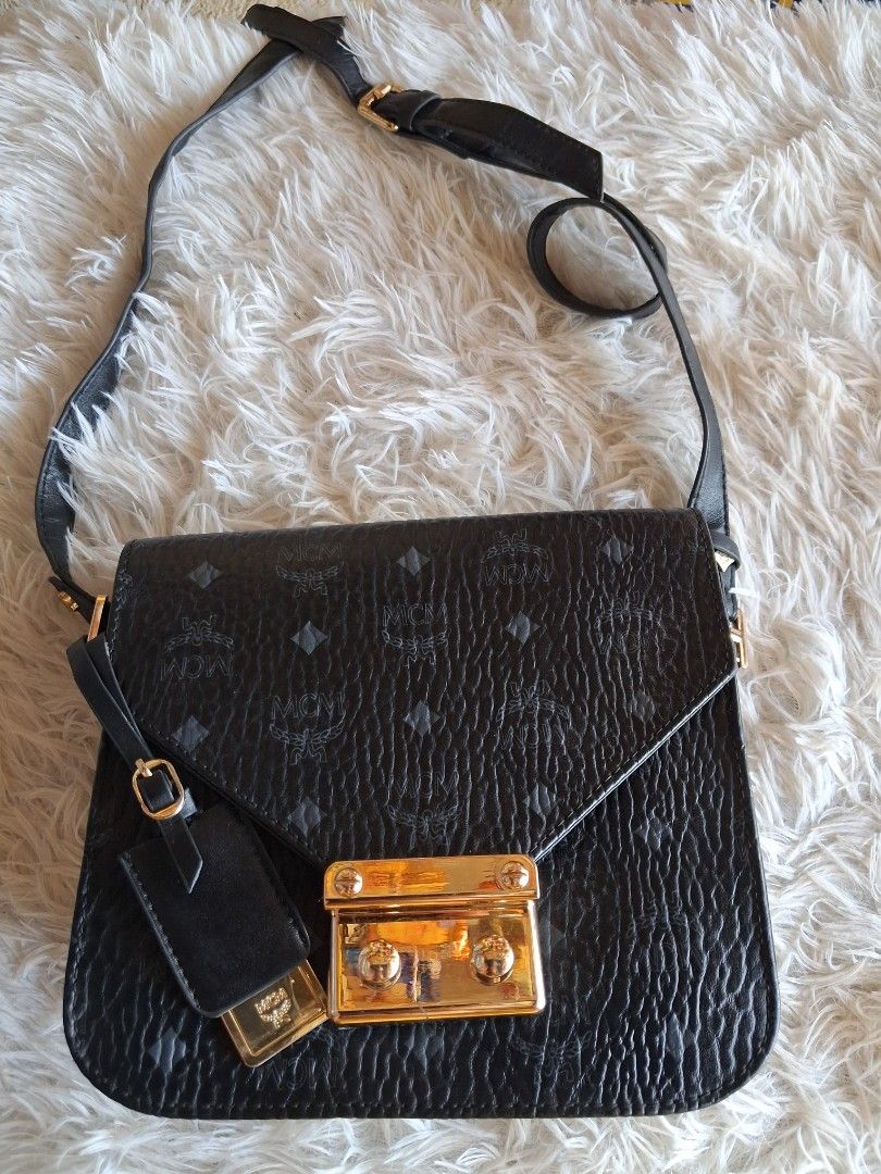 MCM Black Monogram Leather Shoulder Bag (Category: Cross-body Bags) located in Agoncillo. Submitted by vinsoy07 (Listing ID 1464163535, Image 1). Description: - black MCM shoulder bag - Signature monogram print - Textured leather - Gold-tone clasp closure - Adjustable shoulder strap - Minor signs of wear on interior and hardware (pre-loved condition) - Perfect for everyday use.
