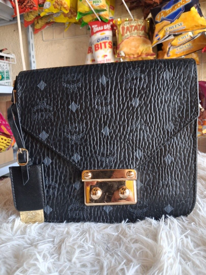 MCM Black Monogram Leather Shoulder Bag (Category: Cross-body Bags) located in Agoncillo. Submitted by vinsoy07 (Listing ID 1464163535, Image 3). Description: - black MCM shoulder bag - Signature monogram print - Textured leather - Gold-tone clasp closure - Adjustable shoulder strap - Minor signs of wear on interior and hardware (pre-loved condition) - Perfect for everyday use.