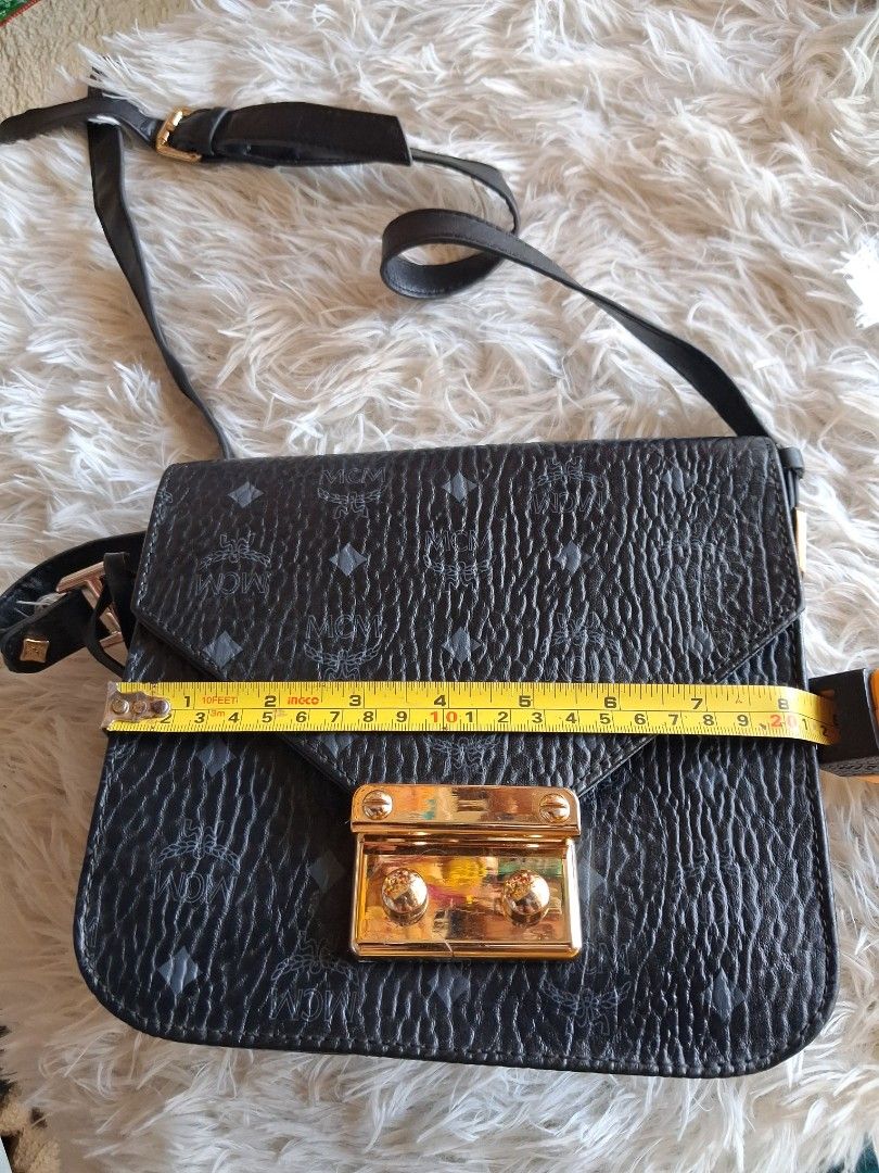 MCM Black Monogram Leather Shoulder Bag (Category: Cross-body Bags) located in Agoncillo. Submitted by vinsoy07 (Listing ID 1464163535, Image 2). Description: - black MCM shoulder bag - Signature monogram print - Textured leather - Gold-tone clasp closure - Adjustable shoulder strap - Minor signs of wear on interior and hardware (pre-loved condition) - Perfect for everyday use.