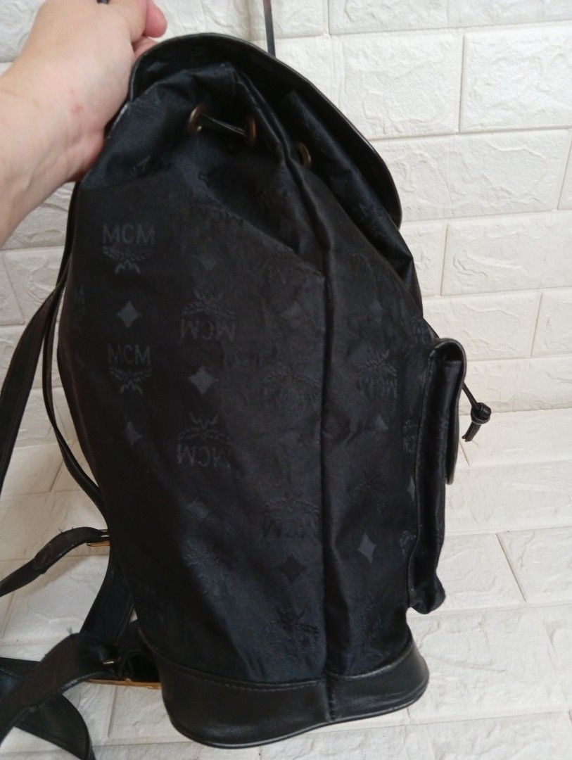 MCM Canvas/Leather Monogram Black Backpack (Category: Backpacks) located in Las Pinas. Submitted by etoksi1234 (Listing ID 1464201966, Image 3). Description: Stylish MCM backpack in black with canvas monogram print. Features leather trim, gold hardware, drawstring and flap closure, front pockets, and adjustable straps. Perfect for everyday use..