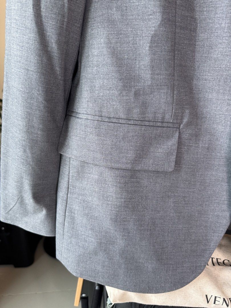 Men’s Slimfit Blazer (Category: Coats, Jackets and Outerwear) located in Mandaluyong City. Submitted by cartmyitems (Listing ID 1464215250, Image 3). Description: - Classic grey blazer - Two-button front closure - Two front flap pockets and one chest pocket - Fully lined interior - Ideal for formal or smart-casual occasions - A versatile addition to any wardrobe.
