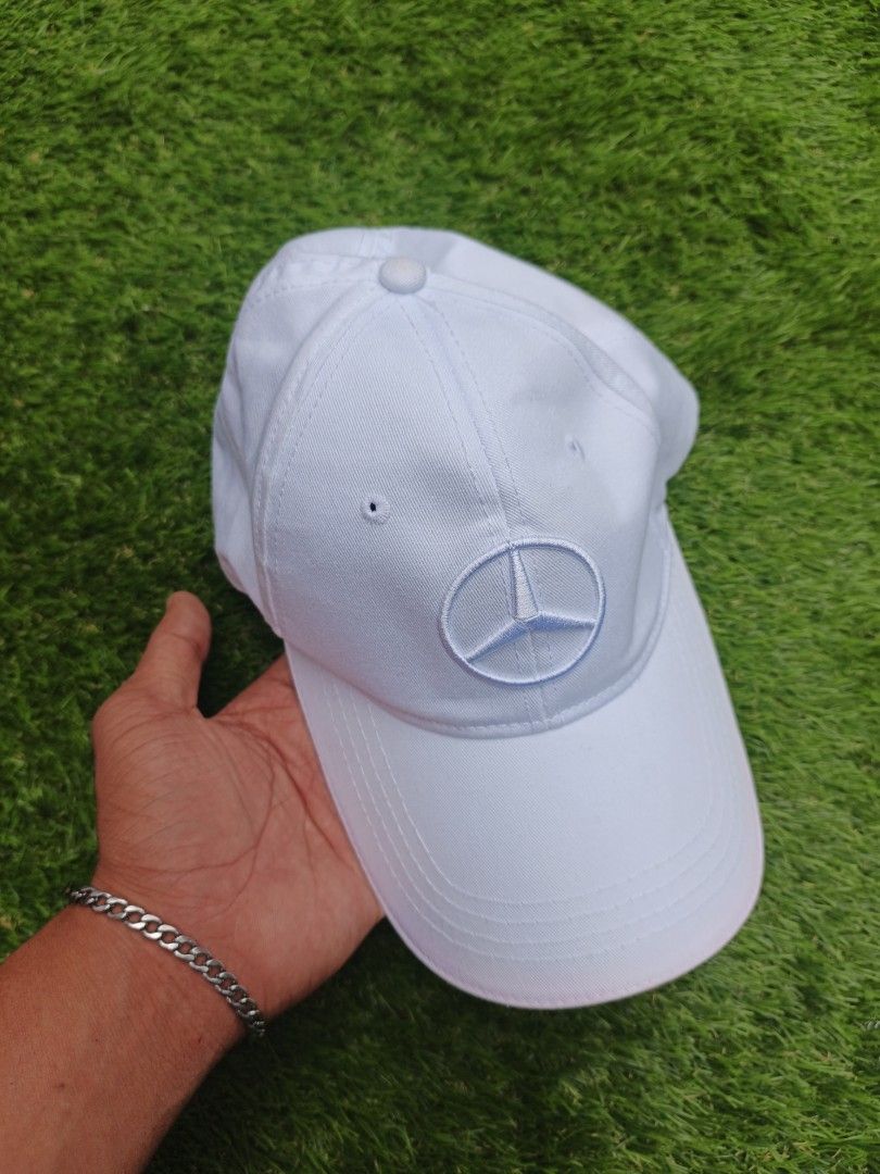 Mercedes Benz Cap White (Category: Caps & Hats) located in Dipolog. Submitted by vinzz_thrift (Listing ID 1464158401, Image 1). Description: - Classic white Mercedes-Benz cap - Iconic embroidered Mercedes logo on the front - Adjustable strap at the back with a stylish red stripe detail - Comfortable polyester and cotton blend fabric - Ideal for everyday wear or showing your love for the brand.