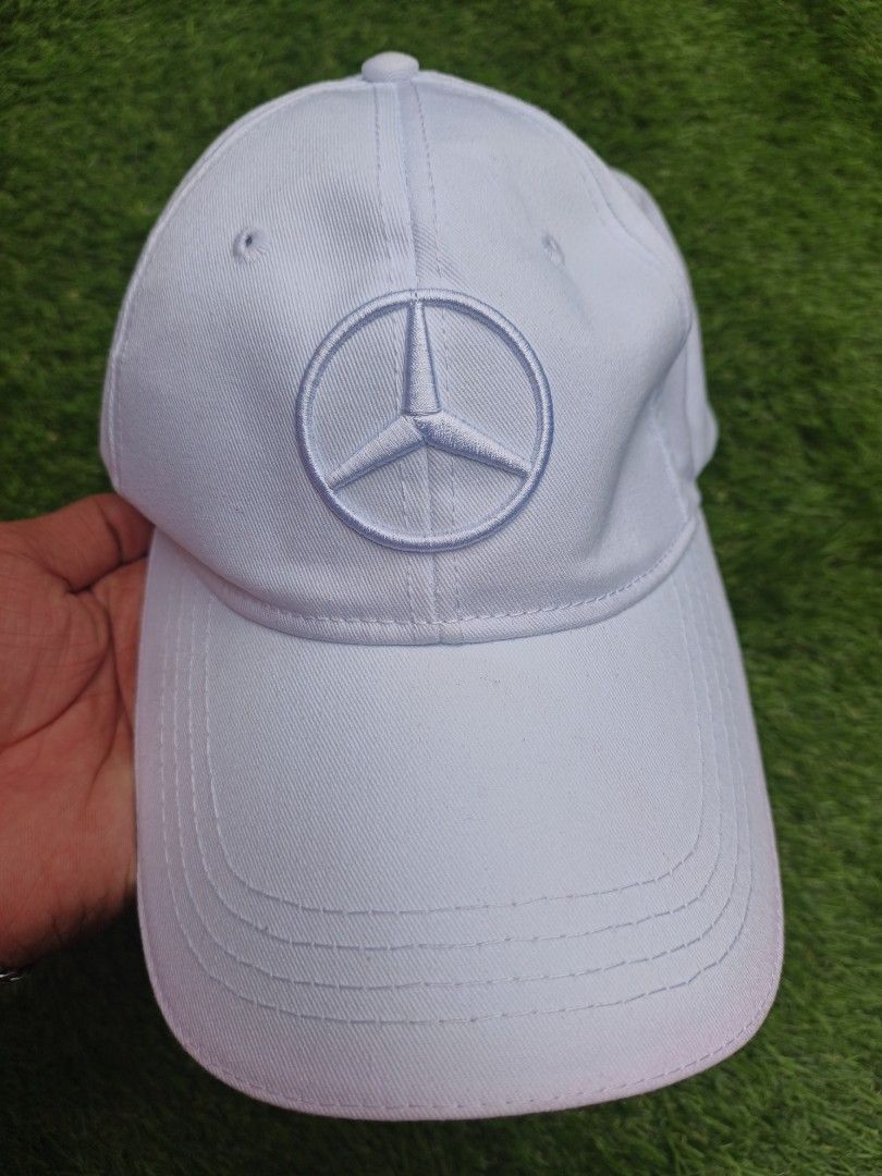 Mercedes Benz Cap White (Category: Caps & Hats) located in Dipolog. Submitted by vinzz_thrift (Listing ID 1464158401, Image 2). Description: - Classic white Mercedes-Benz cap - Iconic embroidered Mercedes logo on the front - Adjustable strap at the back with a stylish red stripe detail - Comfortable polyester and cotton blend fabric - Ideal for everyday wear or showing your love for the brand.