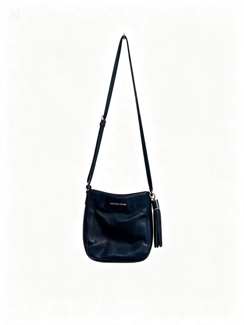MICHAEL KORS (Category: Cross-body Bags) located in Davao. Submitted by sart0ria85 (Listing ID 1464229186, Image 1). Description: Dark Blue Leather bag with a leather fringe on side. With zipper and a leather sling. Pure 100% CALF LEATHER. VERY GOOD CONDITION (87/100) .