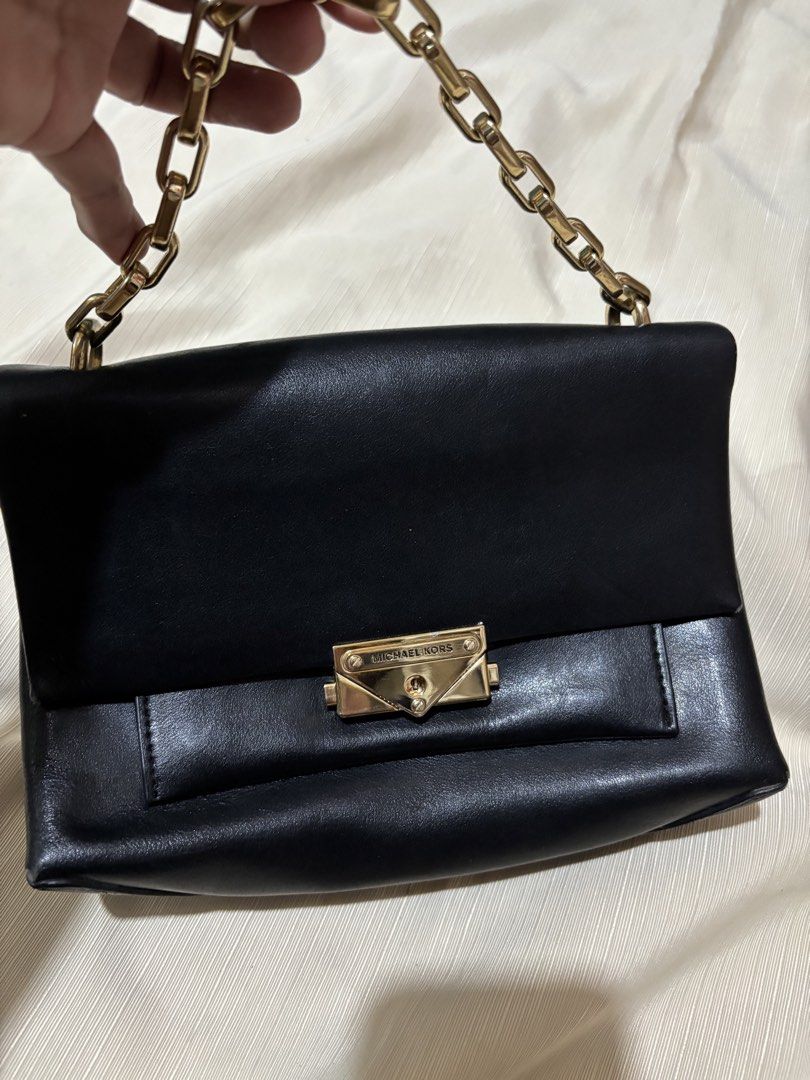 Michael Kors Black Leather Chain Shoulder Bag (Category: Luxury Bags & Wallets) located in Makati City. Submitted by issa124 (Listing ID 1464319245, Image 2). Description: - Authentic Michael Kors black leather shoulder bag - Elegant gold chain strap - Iconic Michael Kors lock closure - Spotless interior - Versatile for day or evening use - Very minimal signs of wear - Ready for its new owner! - Shoulder or hand bag -issue: rubs on all corners as